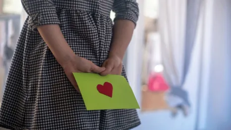 a green envelope with a heart contains a washington college savings account certificate