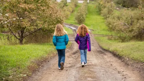Two girls out for a walk on their own enjoying unsupervised play
