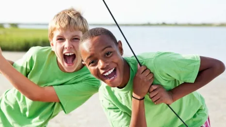 Boys standing on catamaran