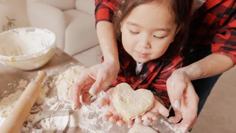 mom and daughter making Valentine's Day treats together in the kitchen