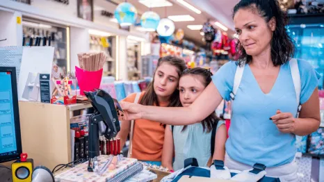 mother and daughters shopping in a store