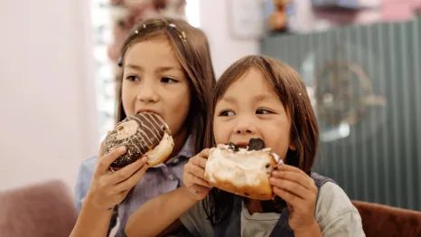 kids eating doughnuts on a walking food tour in Seattle