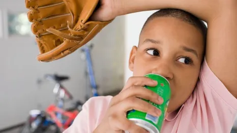 boy drinking from a can