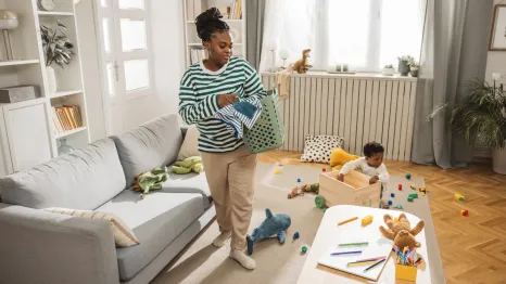 mom and kids picking up toys