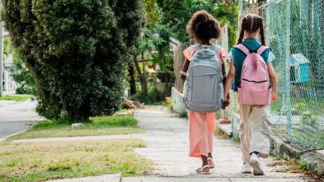two girls walking to school together