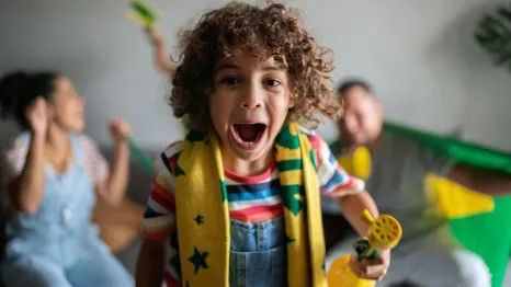 happy kid and family watching fifa