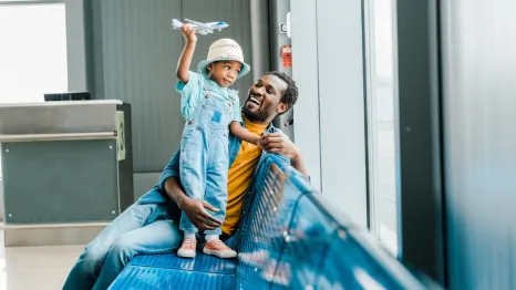 dad at an airport with his son