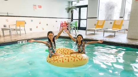 two happy girls at a pool at Maxwell Hotel