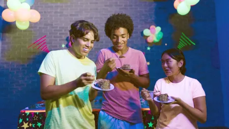 teens eating birthday cake together
