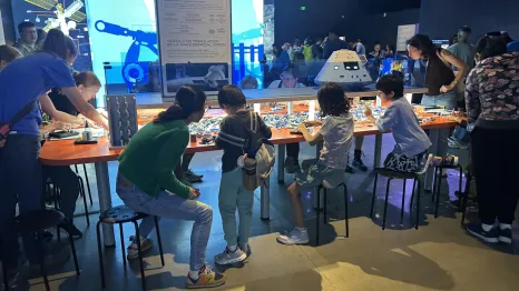 families building with Lego bricks at the 'Artemis Adventure with Lego Bricks'
