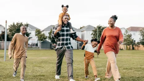 A happy African American family hold hands as they celebrate Juneteenth.