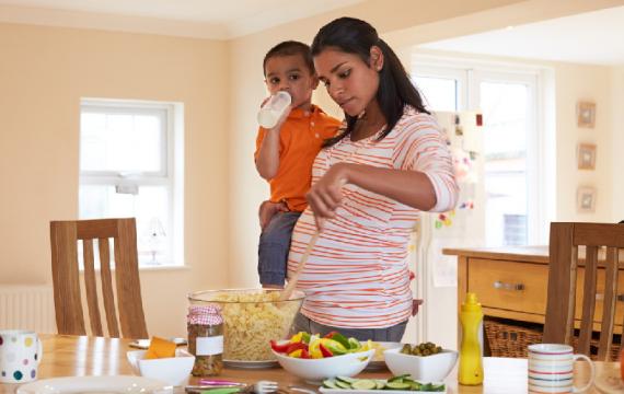 Pregnant-mother-with-toddler-making-salad