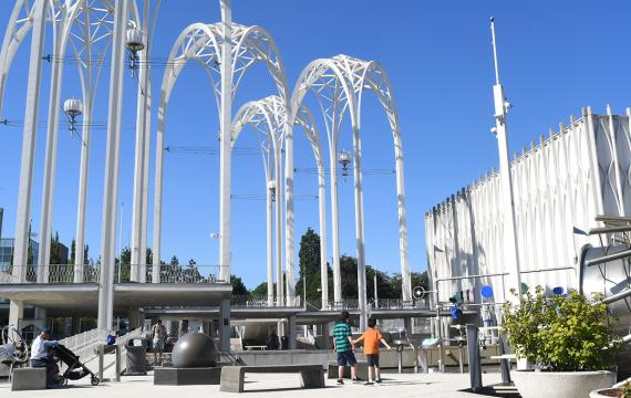 Boys play under the iconic arches of Seattle’s Pacific Science Center, back open after more than two years