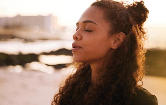 Woman with her eyes closed breathing in deeply