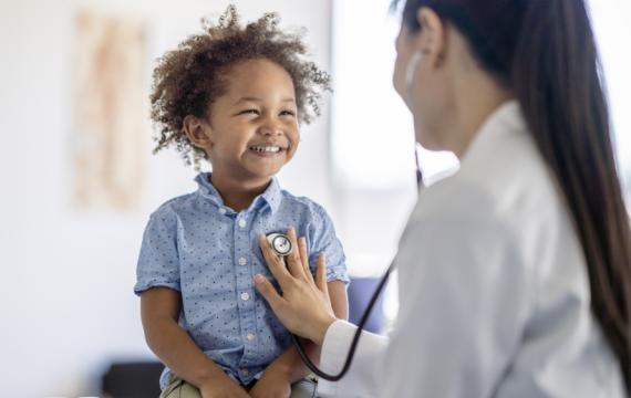 Young boy smiling at a doctor check up