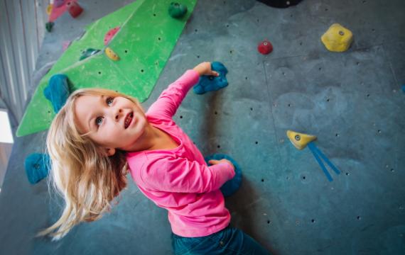 Young girl on a rock climbing wall