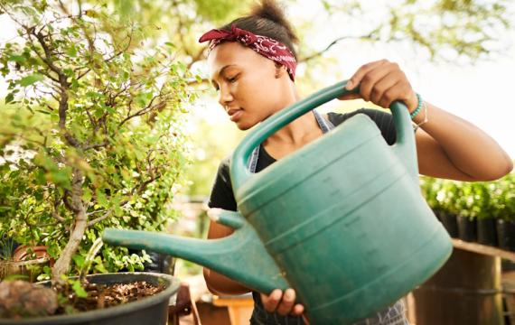 girl watering plants is one of those easy summer jobs for teens that doesn't take much experience