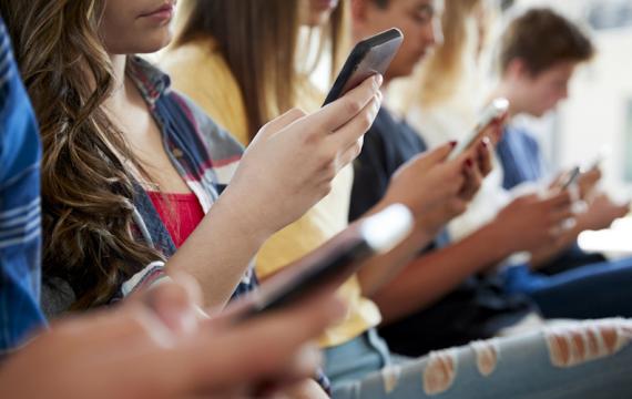 Teenagers using their cell phones