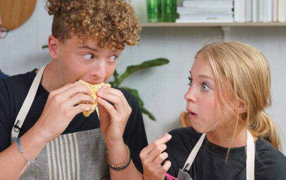 Siblings taste the Greek chicken pita sandwiches they made with Chef Joel