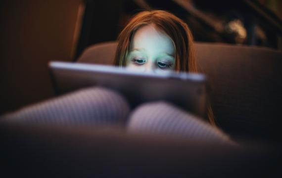 Young girl sitting and watching porn on her computer