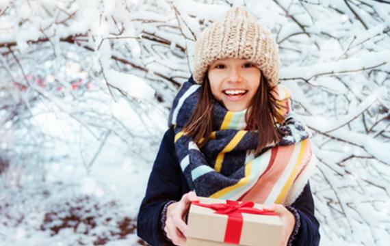 girl with present and snowy background