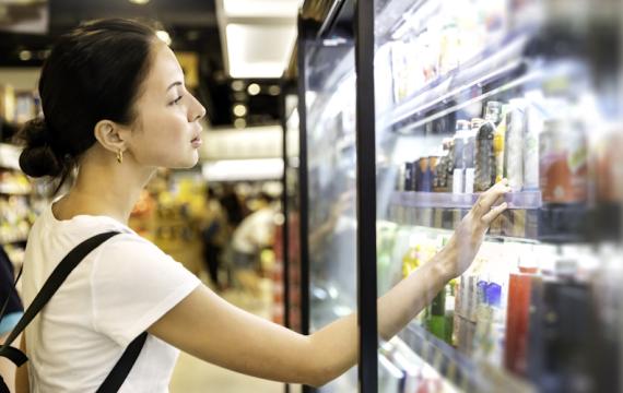 woman looking at cold drinks at a store