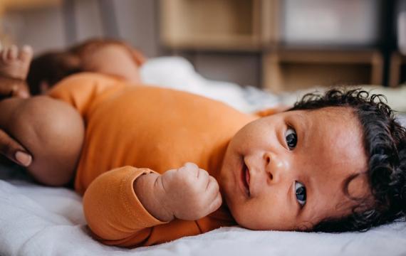 Little baby smiling at the camera