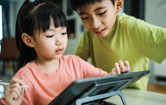 A boy and girl using a tablet together