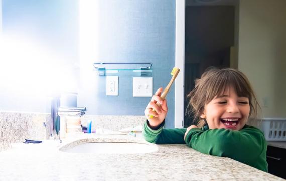 kid using bamboo toothbrush