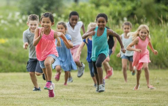 Group of kids running in a field benefits of running