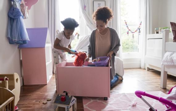Mom and daughter picking up toys spring cleaning with kids