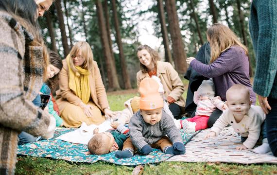 families with babies gather outside to socialize at a support group, an antidote to loneliness epidemic
