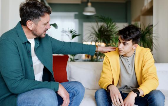 Dad supporting his teenage son with mental health stigma