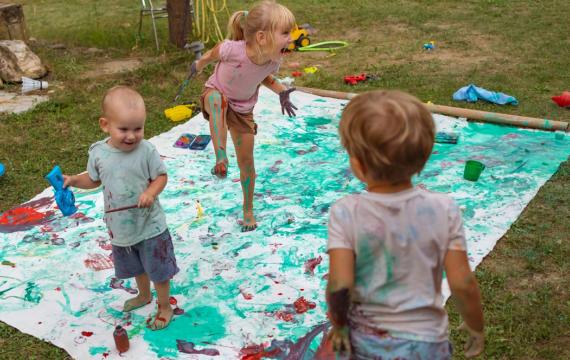 kids doing a messy art project outside