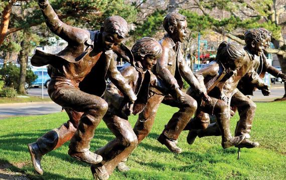 statue of kids running in a park in Kirkland
