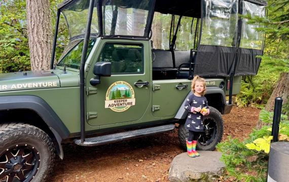 Keeper Adventure jeep with a little girl standing next to it
