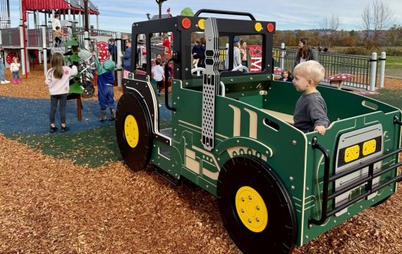 A child at a farm themed playground near Seattle on a sunny weekend