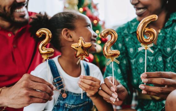 A family holds up balloons showing 2026 for new year's eve in Seattle.