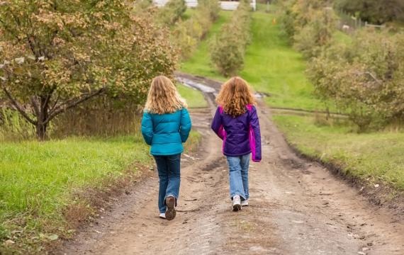 Two girls out for a walk on their own enjoying unsupervised play