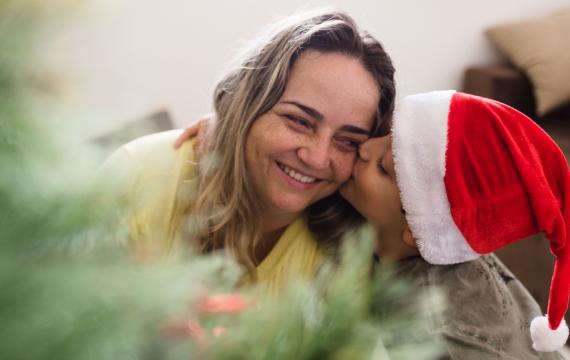 A boy hugs his mom on Christmas morning 