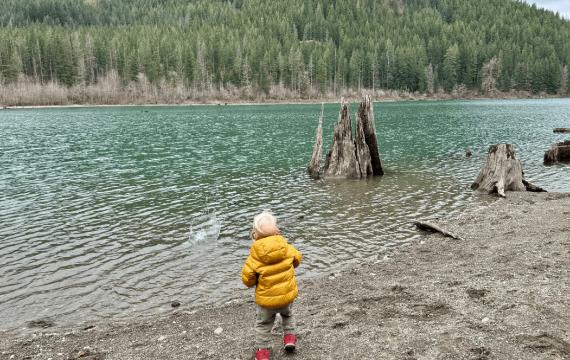 boy playing at the edge of the cedar river