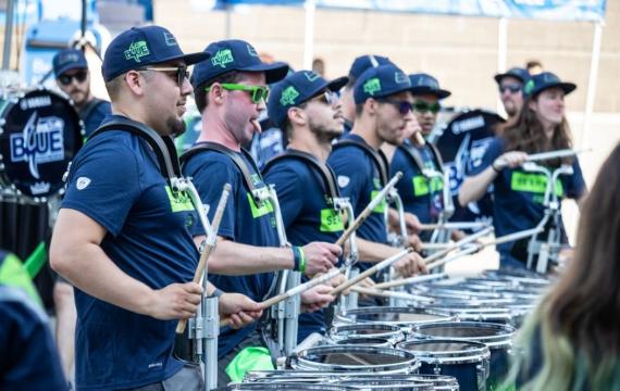 drumline wearing Seattle Seahawks football jerseys in a parade