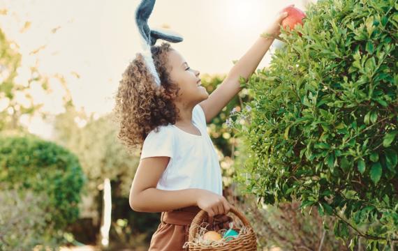 girl finding an Easter egg outside