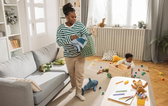 mom and kids picking up toys