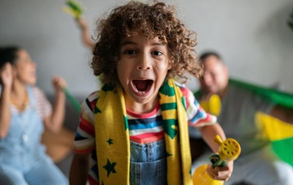 happy kid and family watching fifa