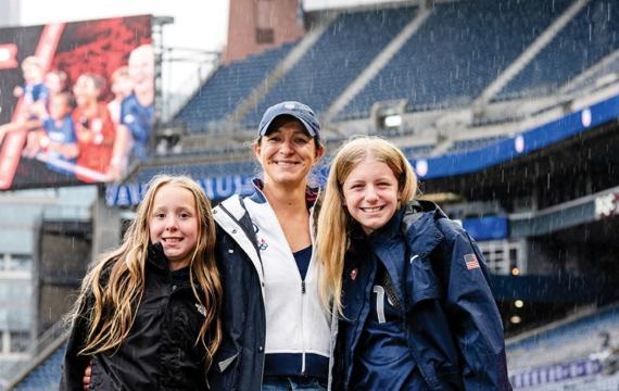 stephanie cox with her daughters in the field
