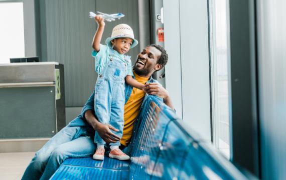 dad at an airport with his son