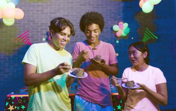 teens eating birthday cake together