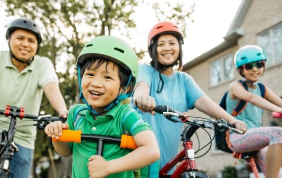family biking outside in summers