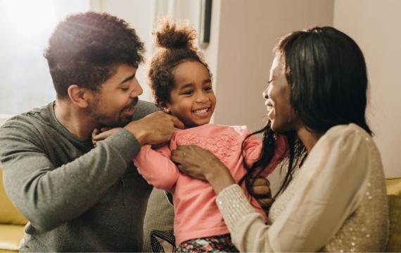 married couple and child in living room
